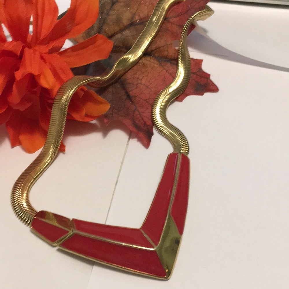 Necklace gold and red arrow design.